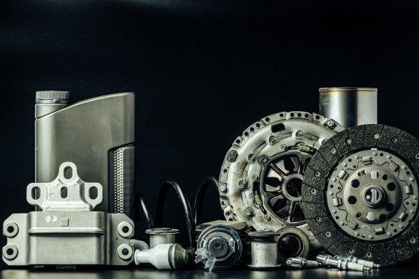 Close up of set of new car parts on black background